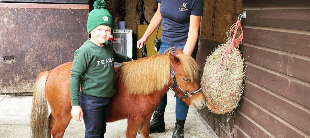 Boy wearing green with an orange Keysoe Pony